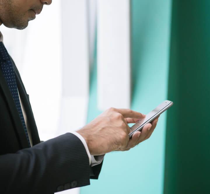 Man text messaging in suit