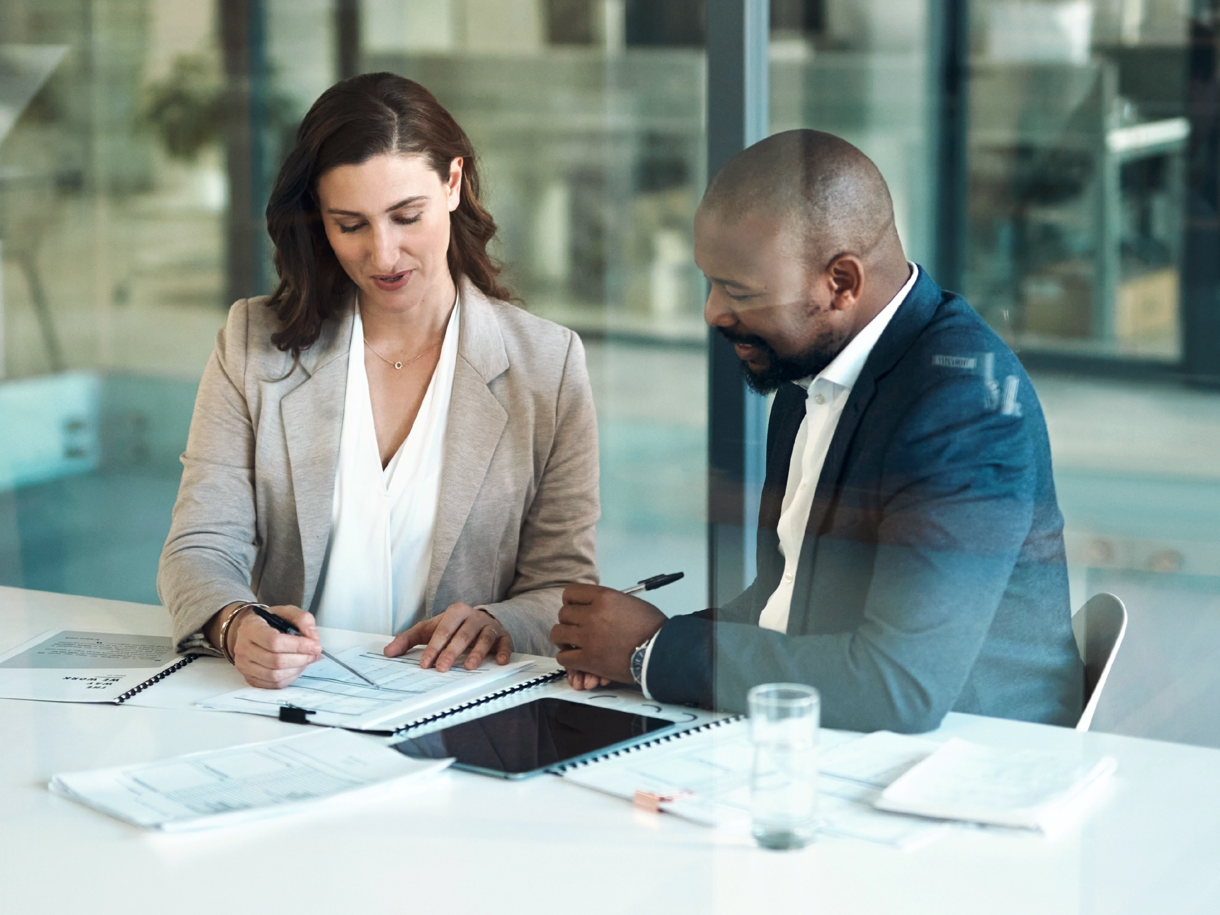 Lawyer sorting through papers with another staff member
