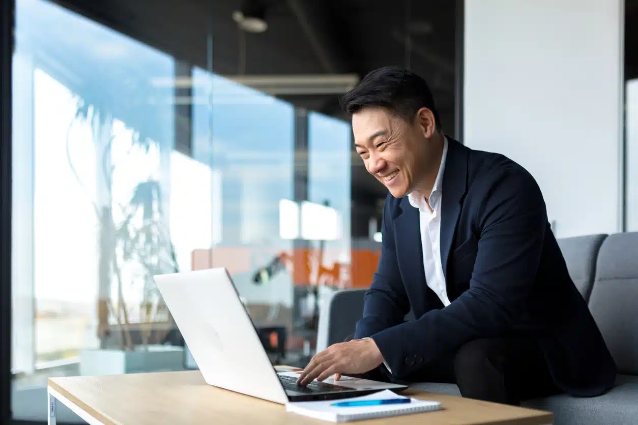 Person smiling at laptop