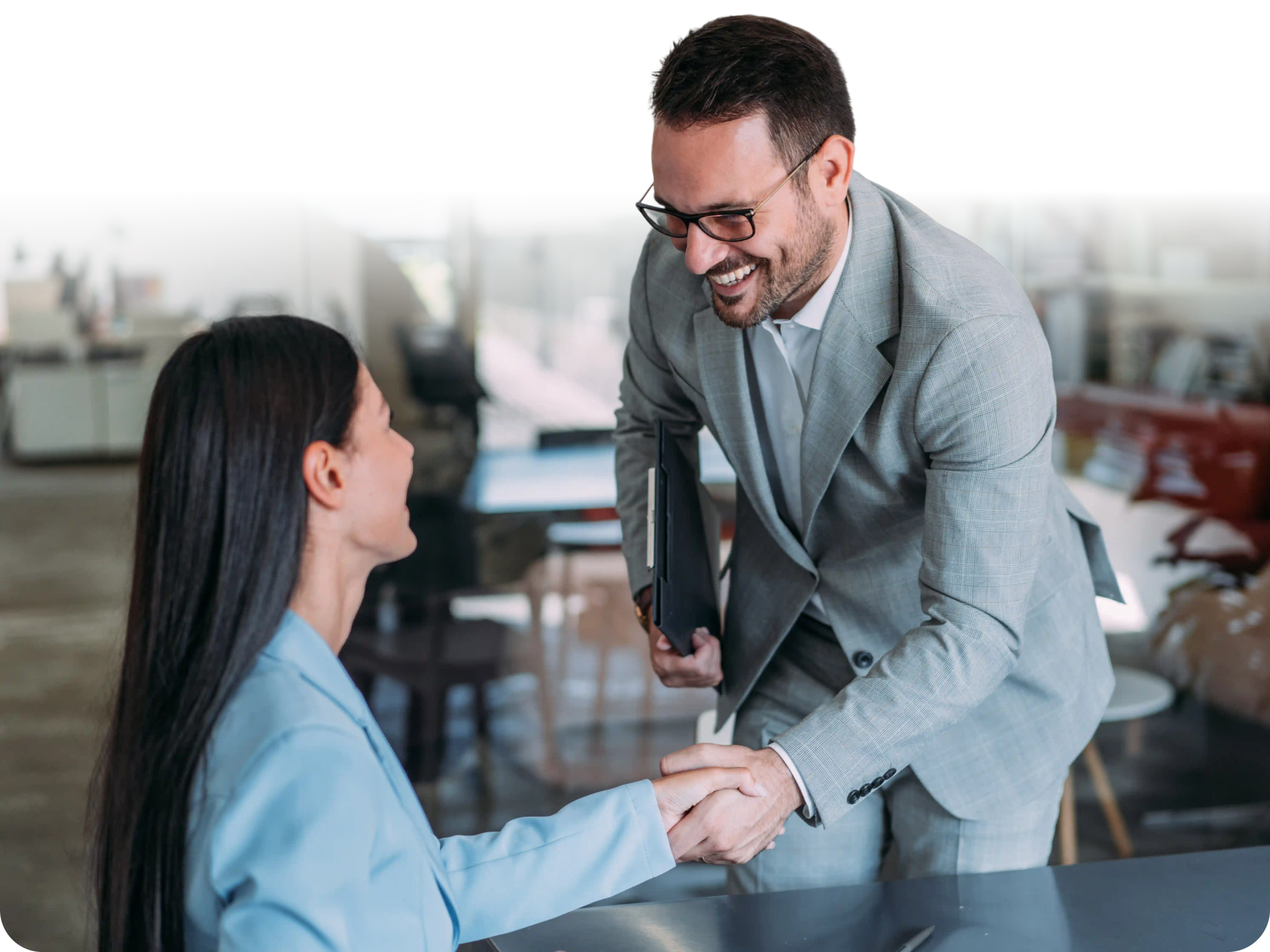 Lawyer and client shaking hands while smiling