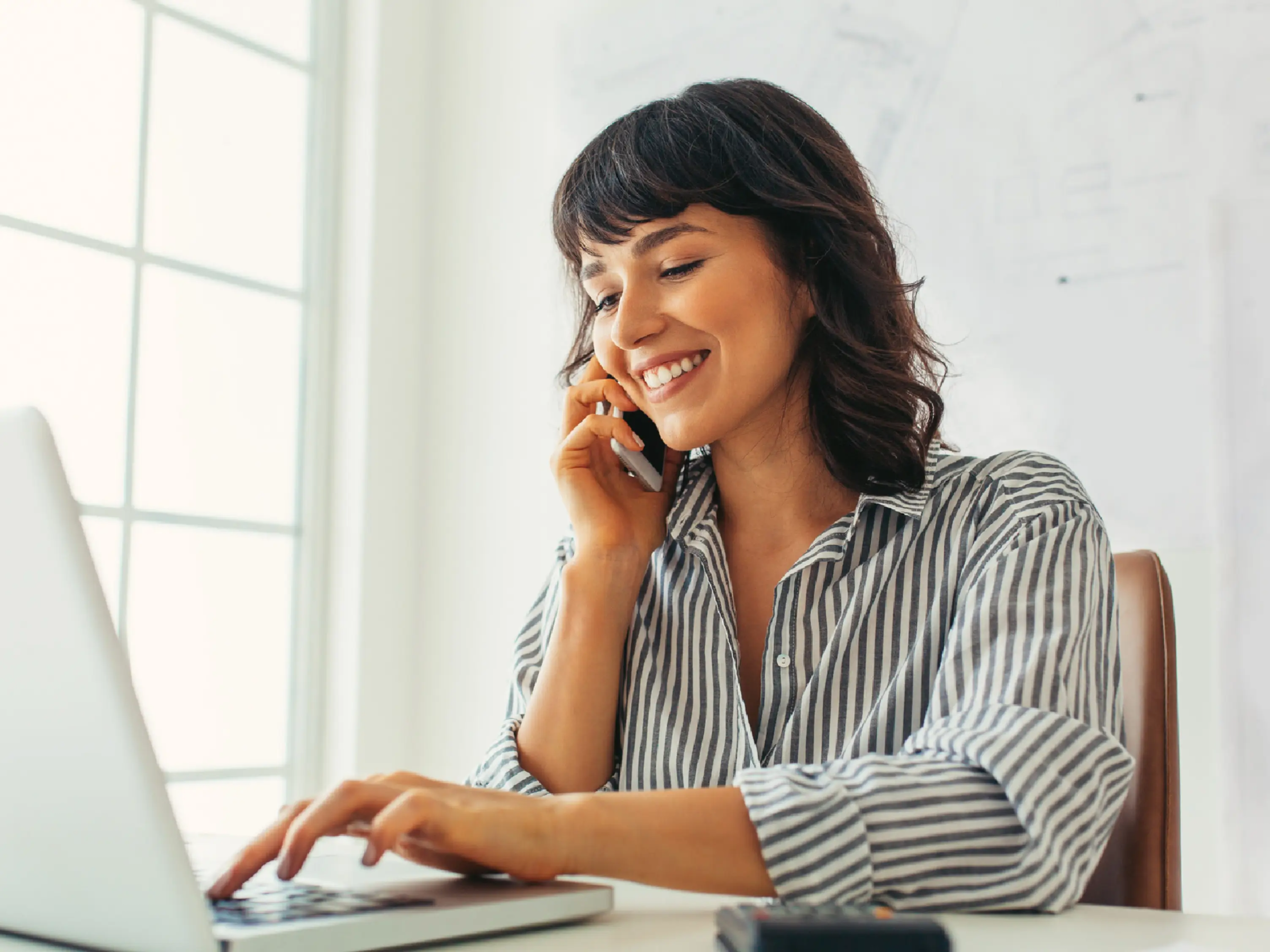 A consultant talks with a client on the phone