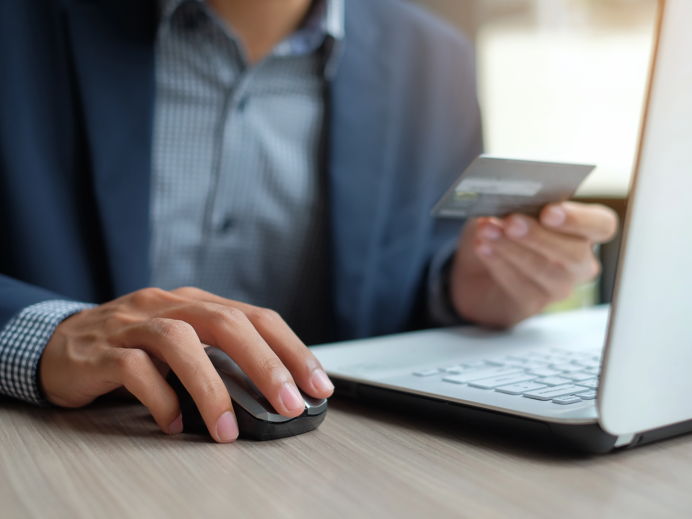 Lawyer processing a credit card payment on their laptop