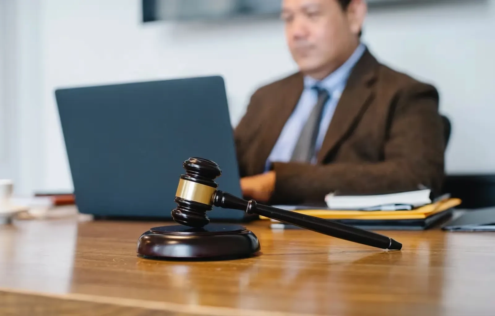 lawyer sitting in a desk in front of a laptop