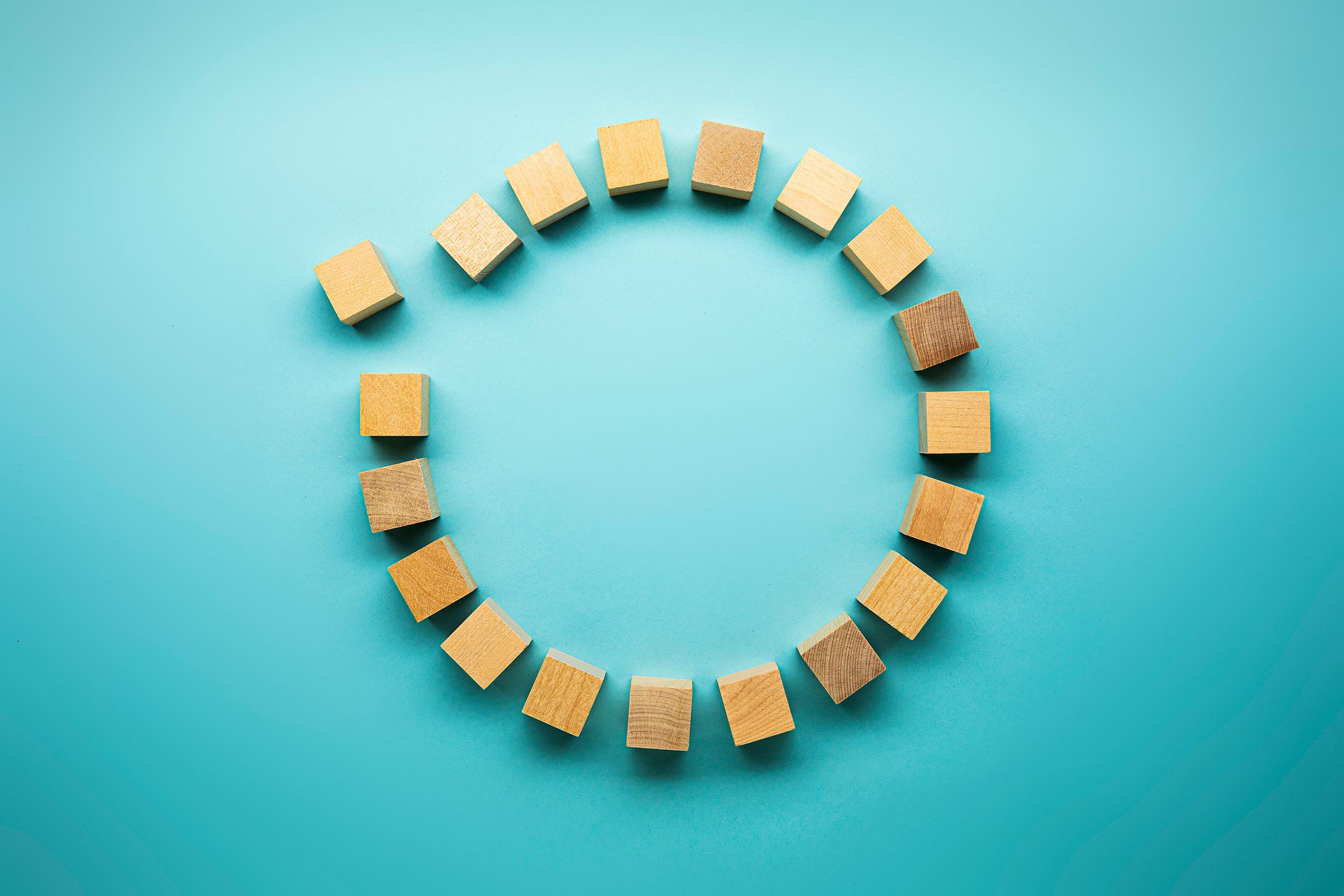 Wooden blocks in a circle on a blue background