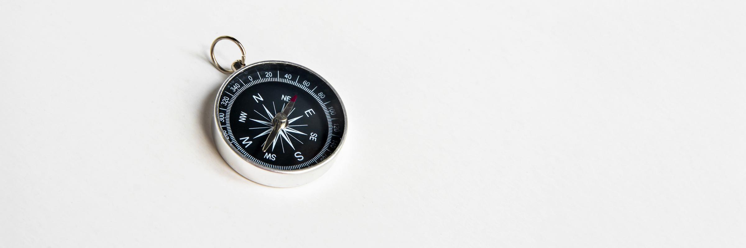 A black compass on a white background