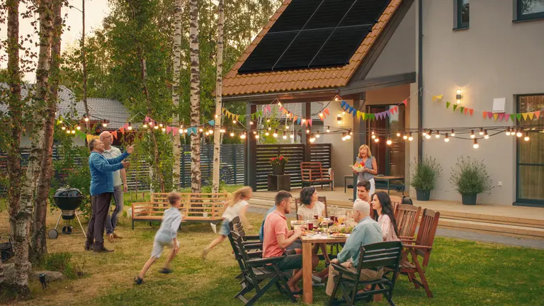 Outdoor party with solar panels on roof visible