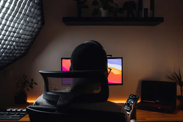 man sitting at computer with uninterrupted power supply