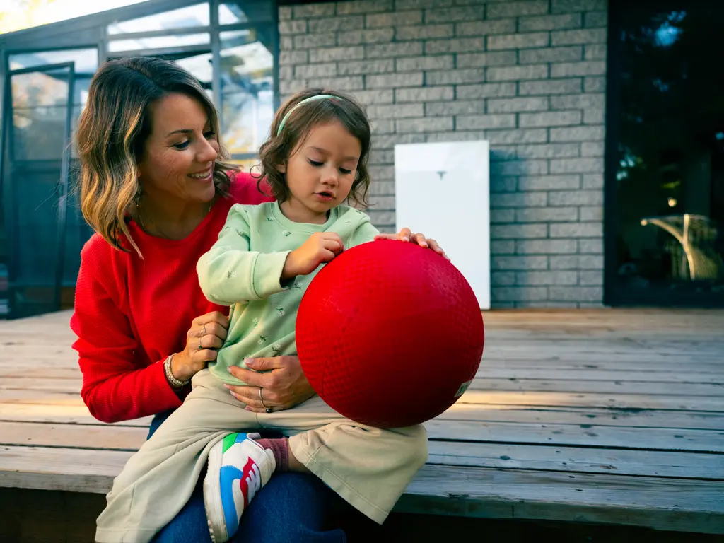 mother and daughter outside a home with solar battery storage