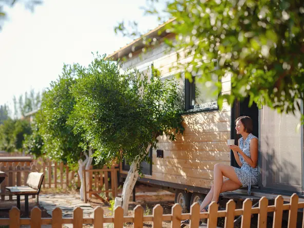 woman sitting outside her tiny home