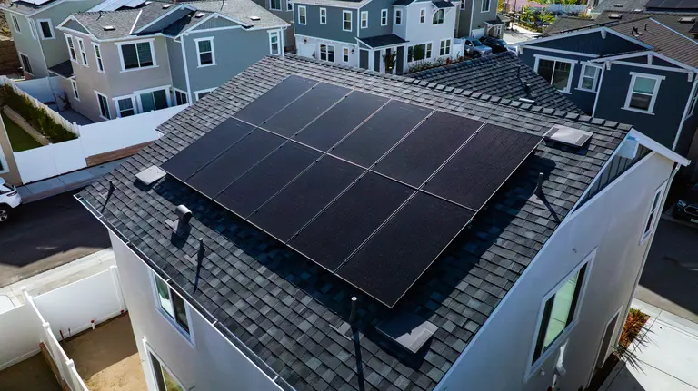 close up of black on black solar panels on roof