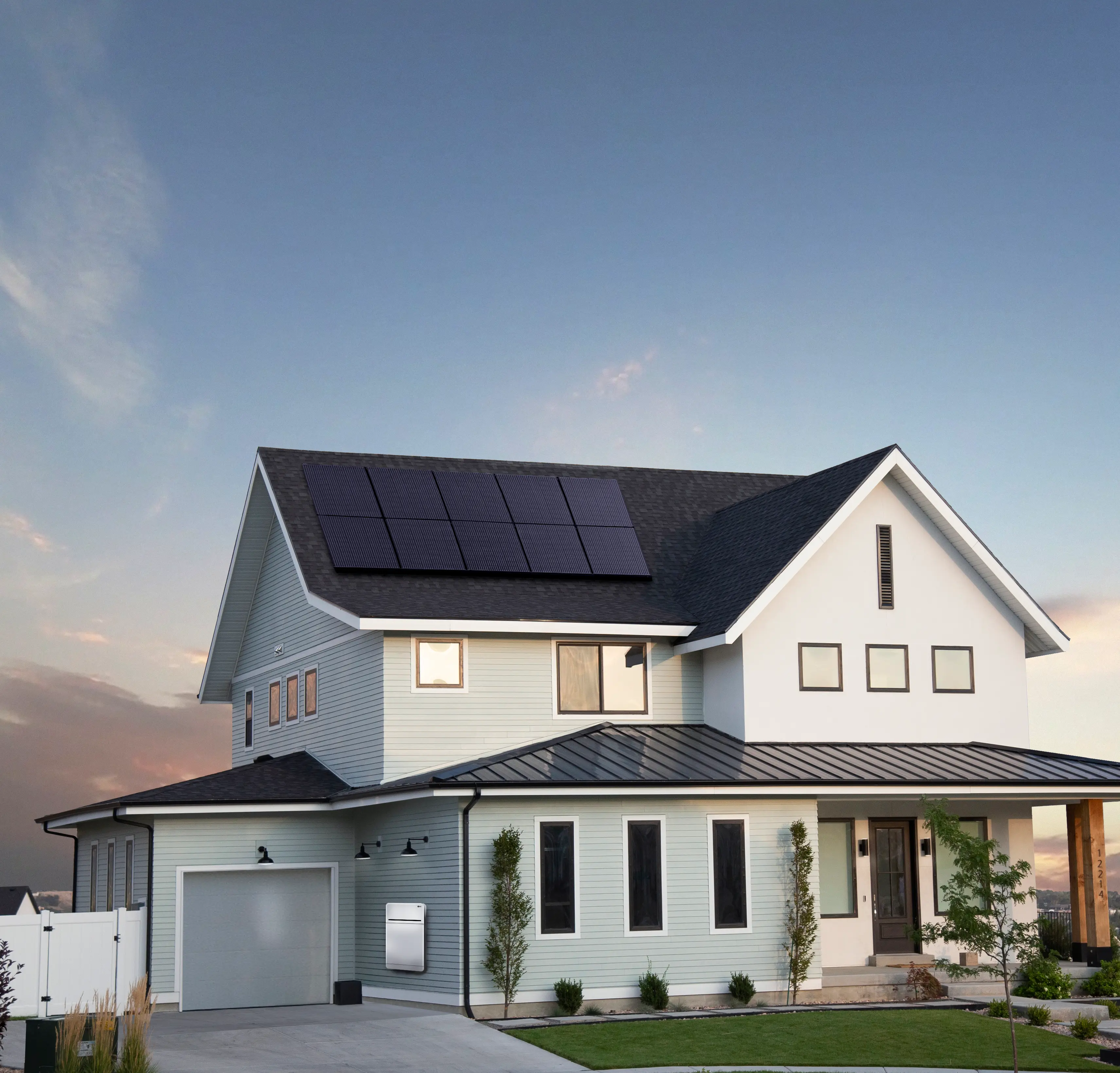 2 story house with solar panels on the roof at sunset