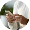Zoomed in view of a person in a white shirt holding a smartphone