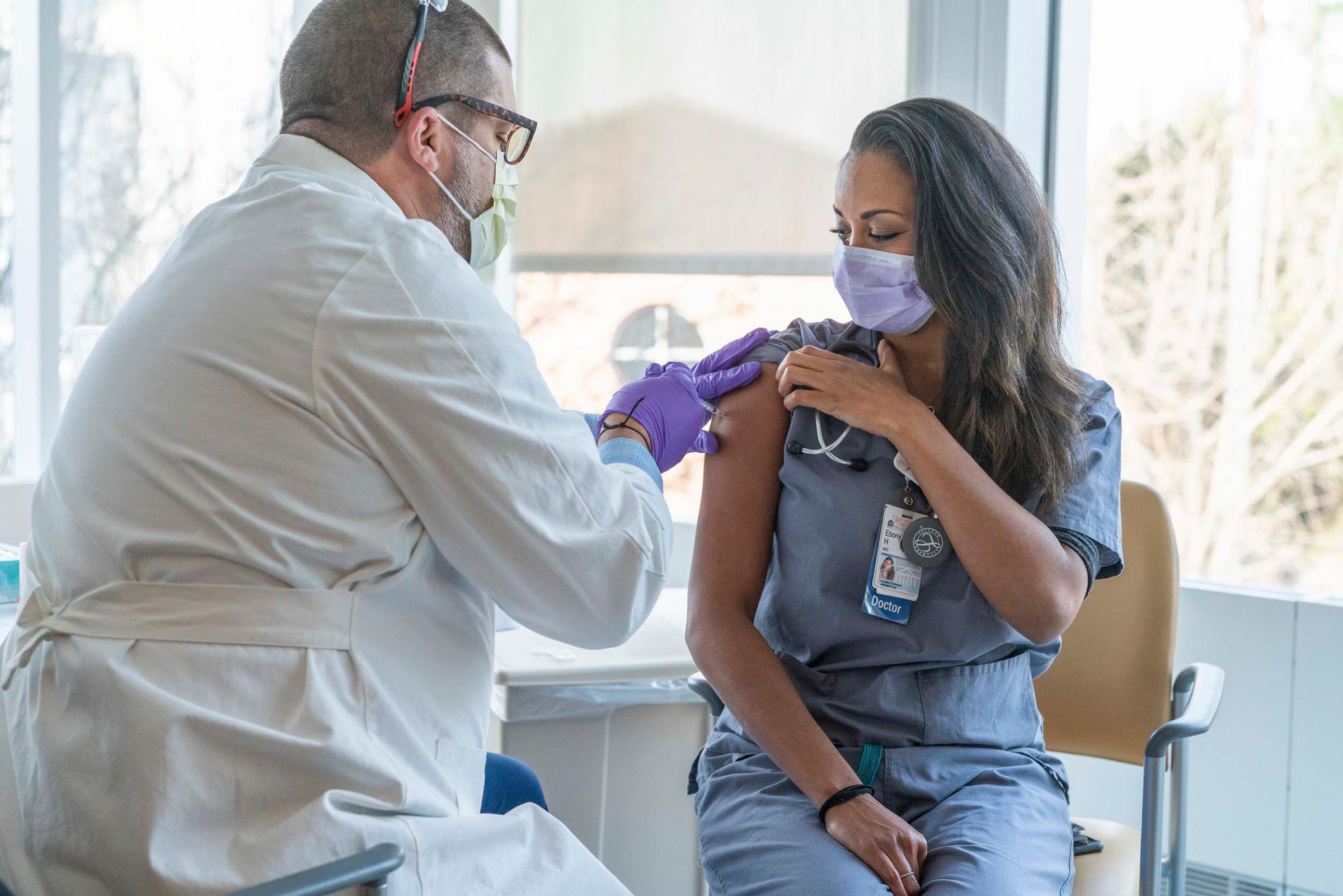 Dr. Ebony Jade Hilton receives the first vaccination for COVID-19 administered to care providers at UVA Health.
