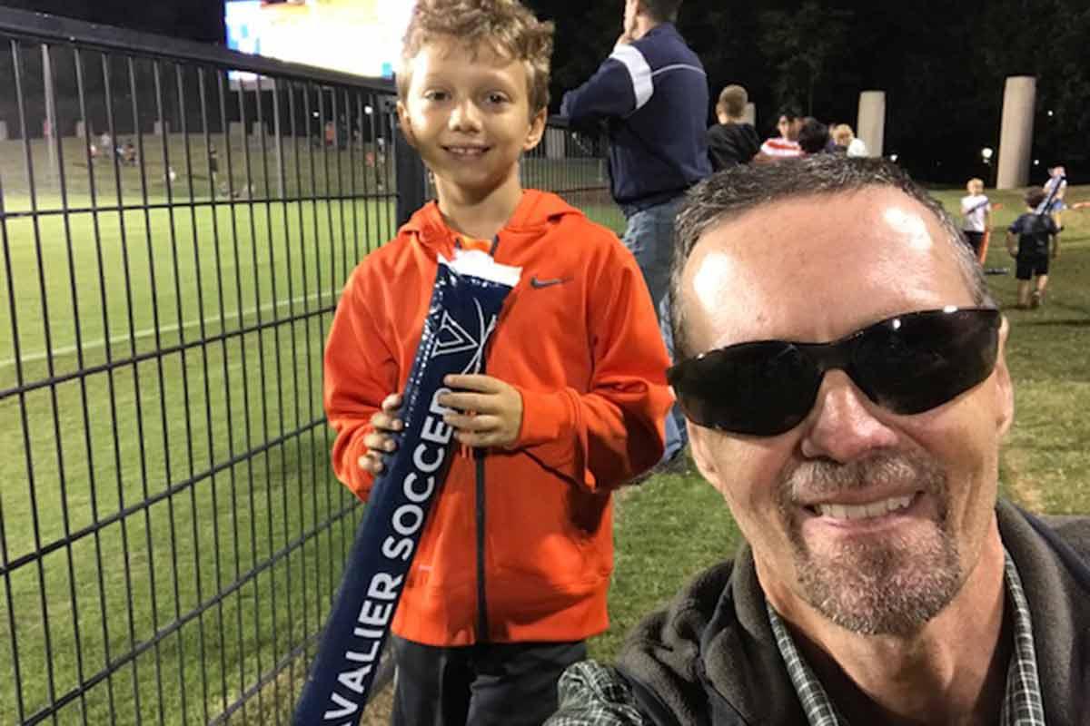 Soon after his melanoma surgery, Jamie took his son to a UVA soccer game. He wore sunglasses to protect his healing eyelid.