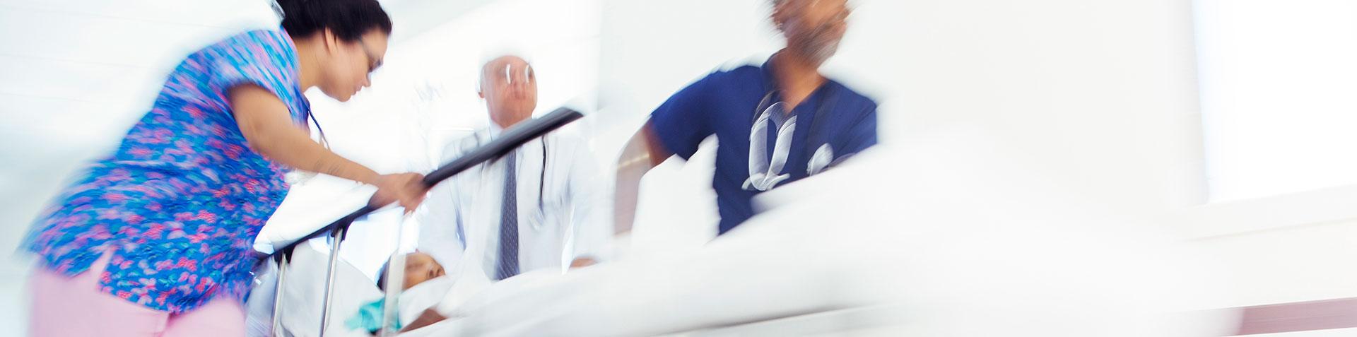 A UVA ER team pushes a patient on a gurney