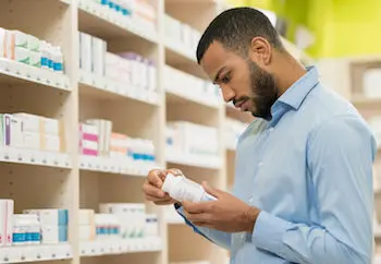 Man shopping for supplements in the drugstore