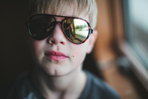 boy wearing sunglasses indoors