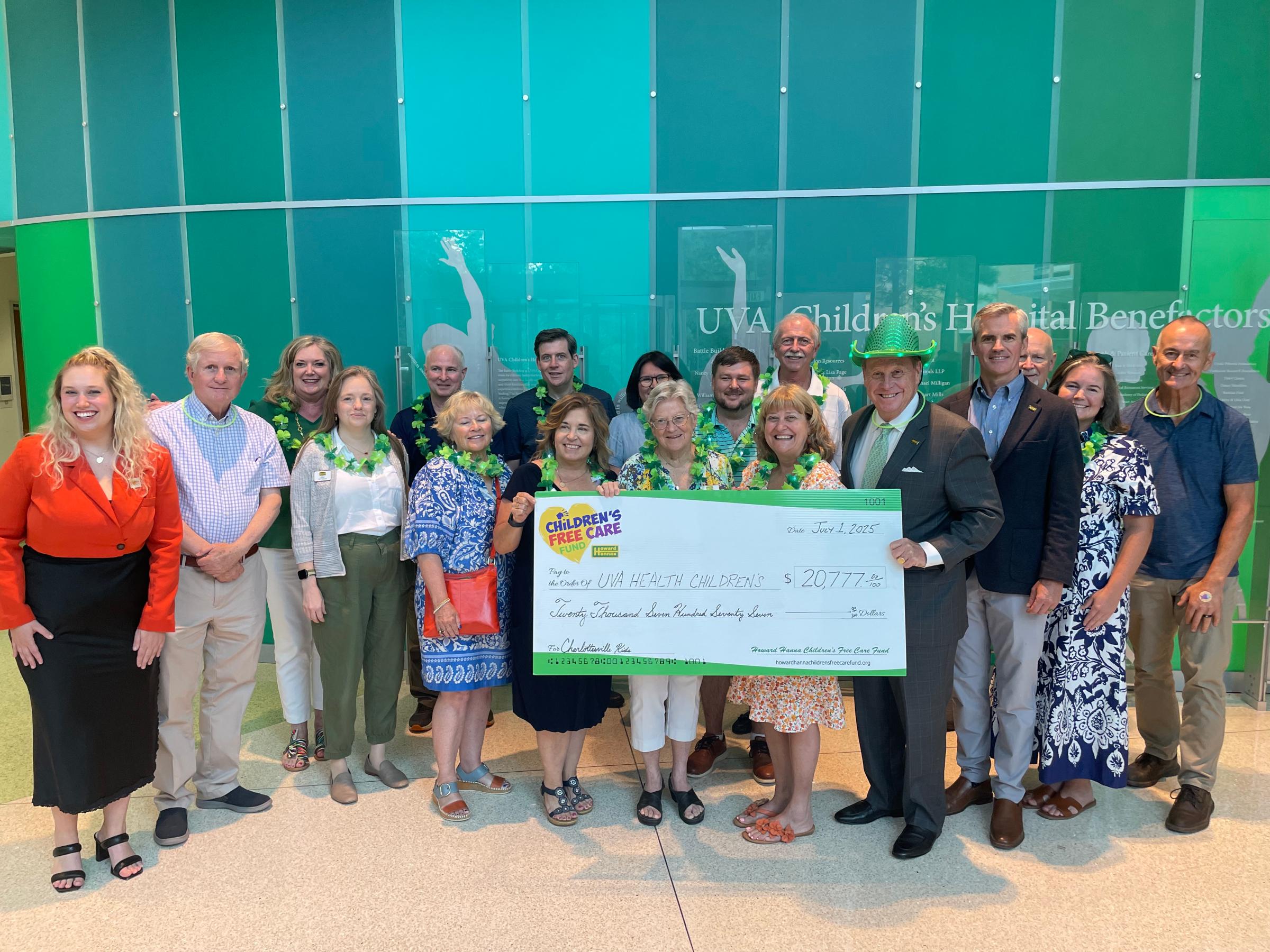 Howard Hanna Real estate agents hold up a large check for UVA Health Children's 