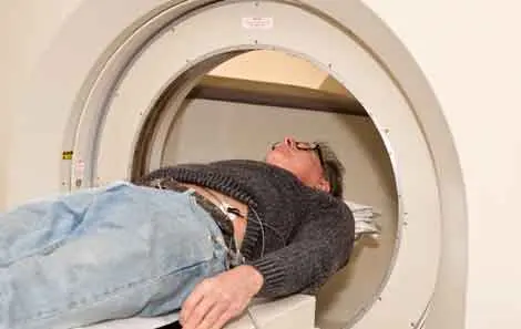 Man laying on back goes into CT scan