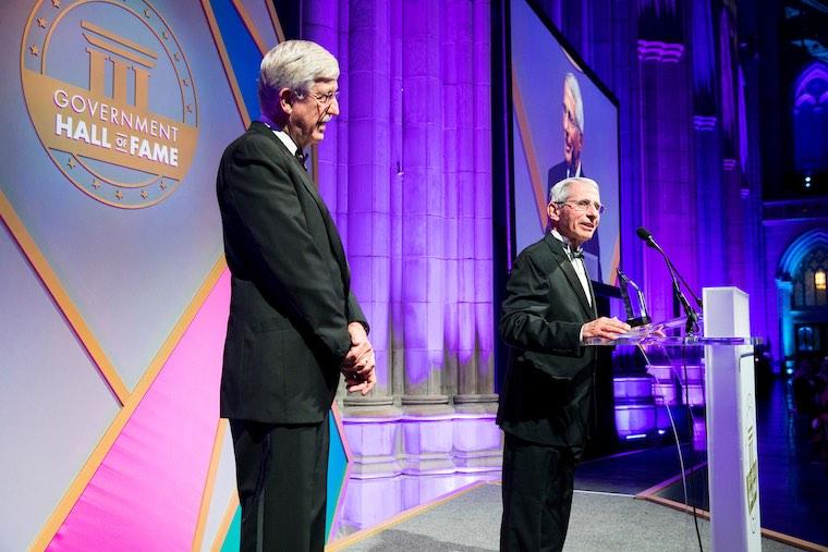 National Institute of Allergy and Infectious Diseases Director Dr. Anthony Fauci speaks at the Government Hall of Fame gala in Washington, D.C., where he was presented for induction by NIH Director Dr. Francis Collins (left). Dr. Fauci was chosen for the Government Hall of Fame for his pioneering efforts with HIV/AIDS and for his distinguished career as a public servant. (Photo courtesy of National Institutes of Health)