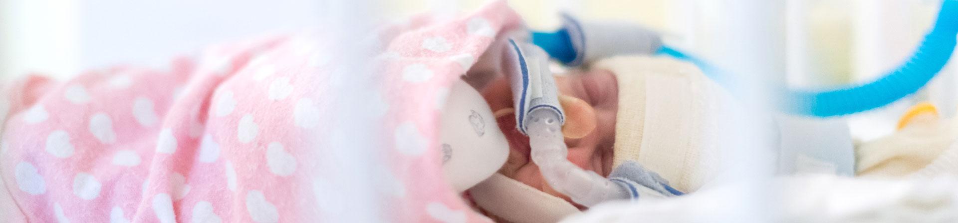 A baby lying down in UVA'a NICU. 