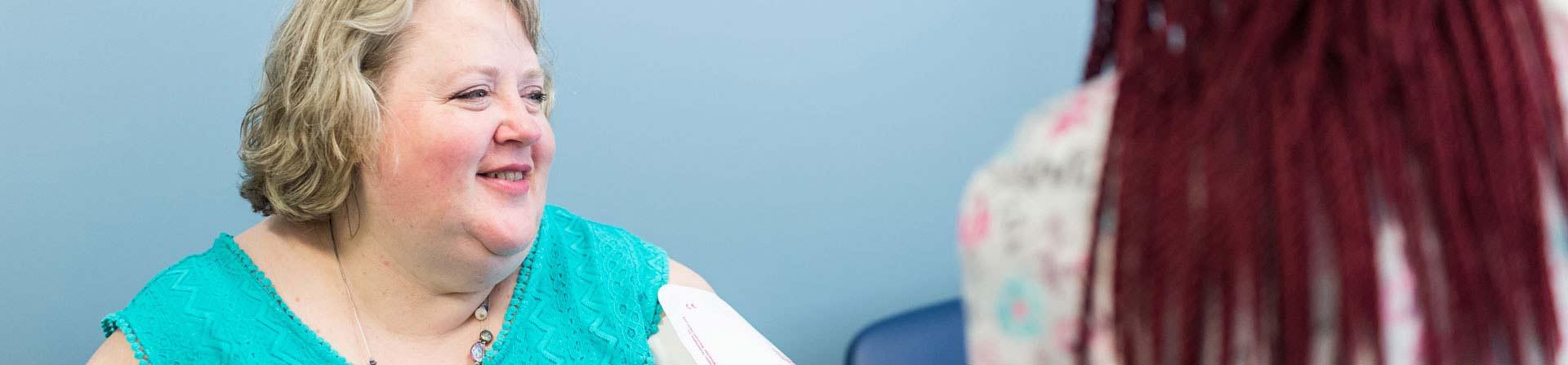 woman and nurse speaking in clinic