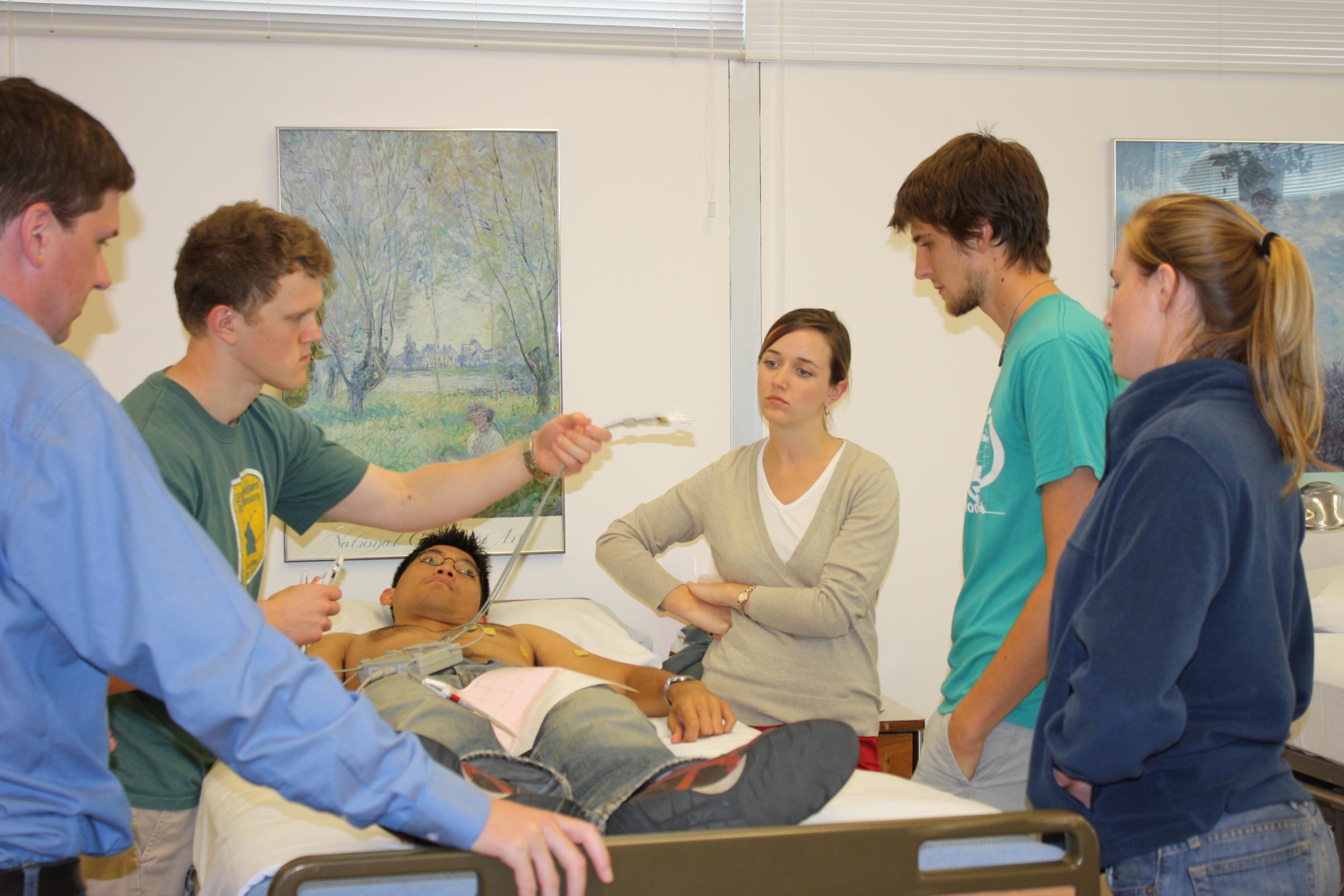 Students practice using an ECG machine