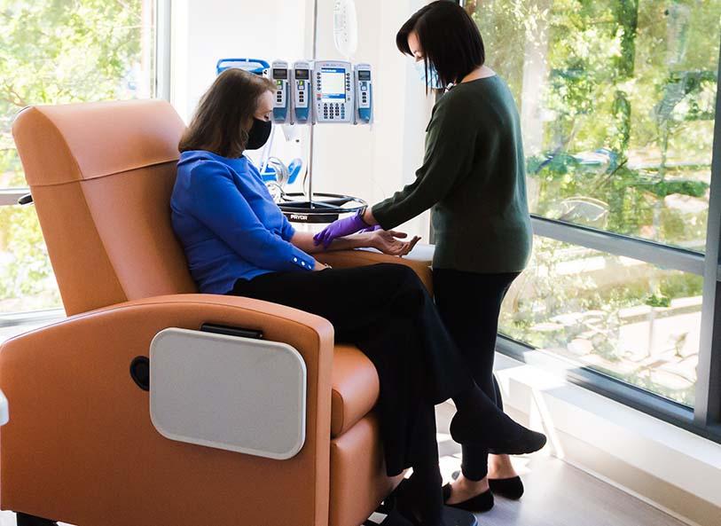 A woman receives an infusion at UVA Health Breast Care Center