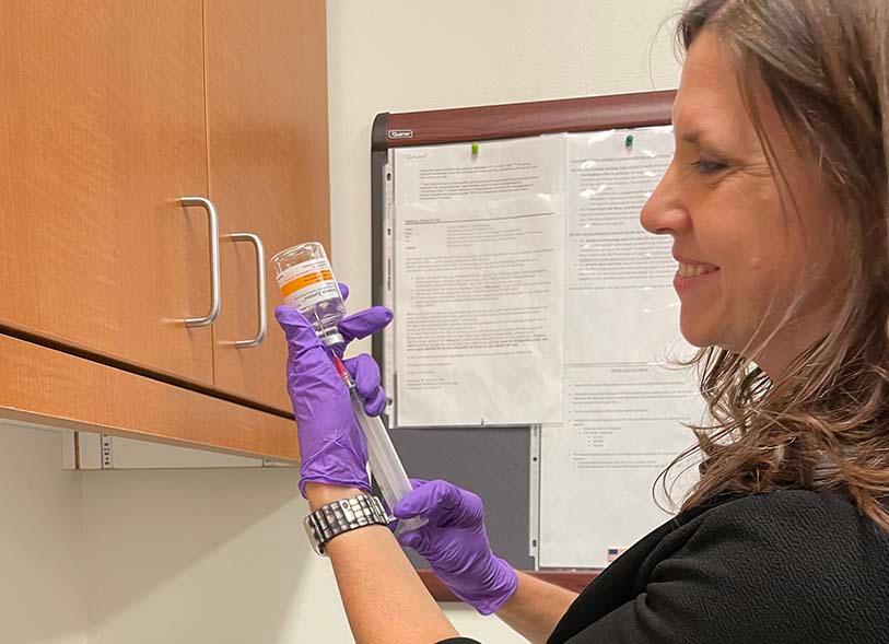 a clinician draws up a medication