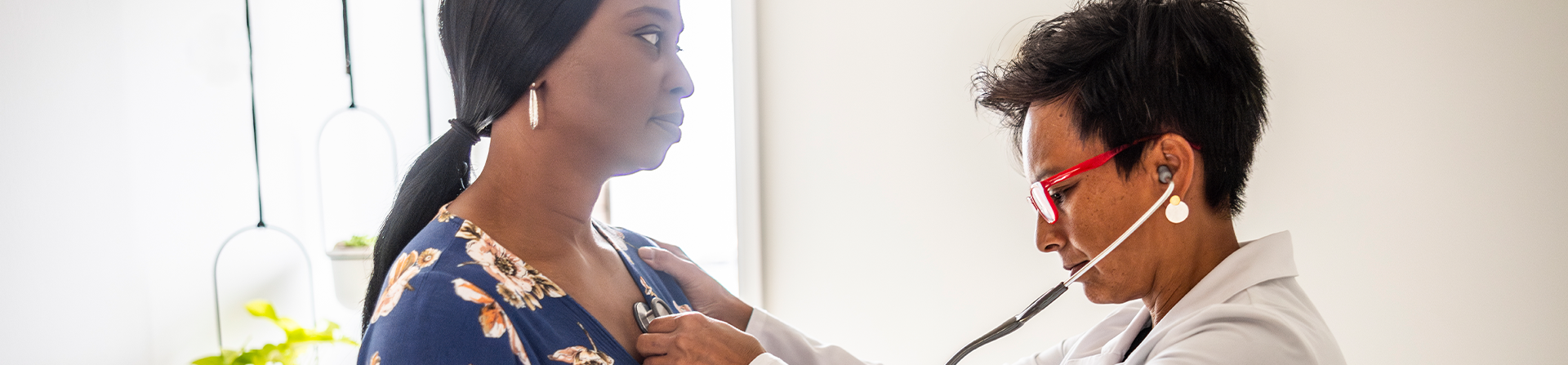 A provider listening to the heart of a adult congenital heart disease patient