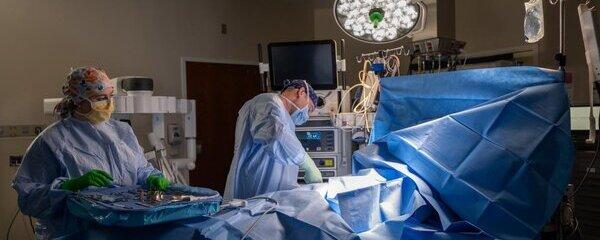 Heart surgeons in the operating room with a patient