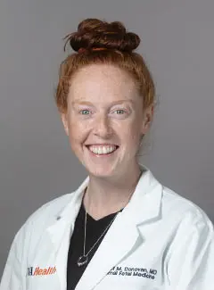 headshot of young doctor in white coat