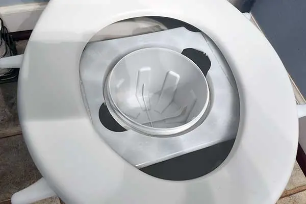 This tray fits under the toilet seat. It's helpful to have a clean seat.