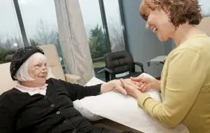 UVA massage therapist Deborah Caudle, right, cares for Mary E. Scott, a patient at UVA Hope Cancer Center in Charlottesville.