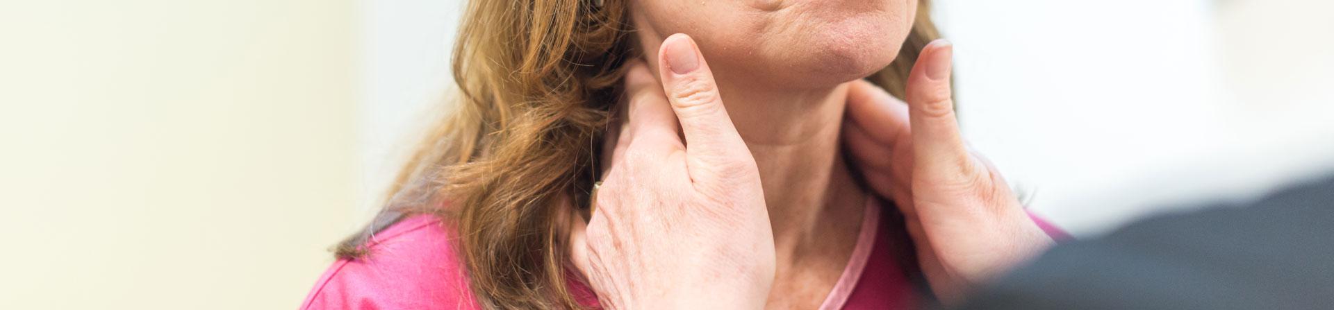 doctor checking patients glands in neck