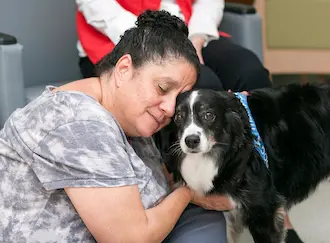 Ollie comforting a patient while visiting the hospital