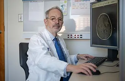Dr. David Schiff sits at a computer
