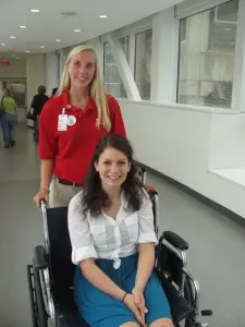 Summer volunteer Rebecca Brookman practices her wheelchair skills with Volunteer Services intern Stephanie Sisak.