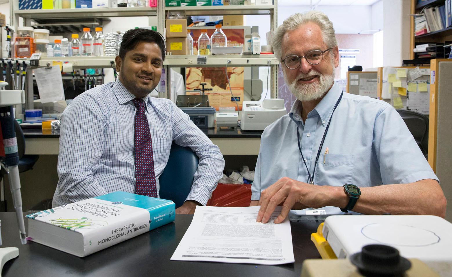 Biologists Eusebio Pires (left) and John Herr are looking at ways to treat cancer with fewer side effects.