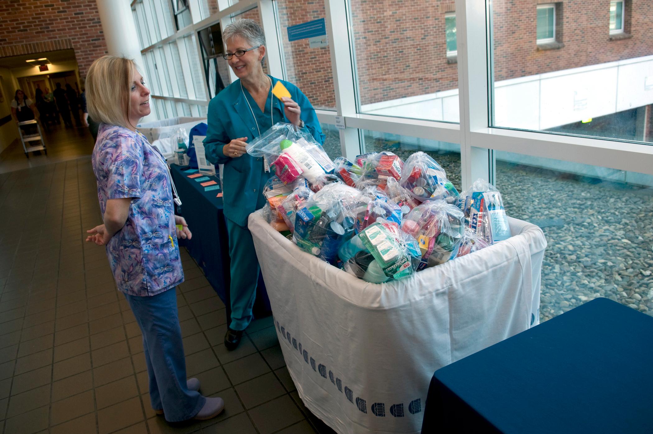 RNs Kelly Ritz (left) and Kathy Sullivan donated their teen care kits during the Sept. 28 event.