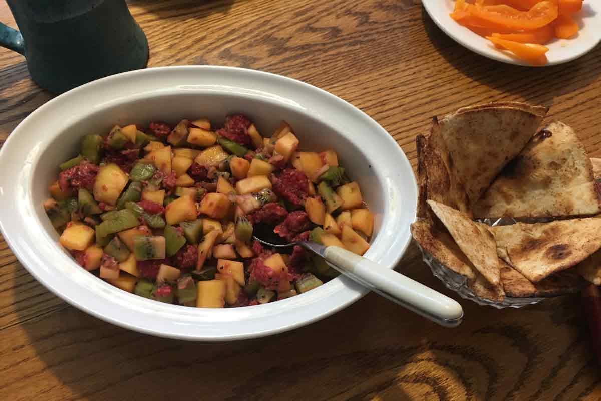 Fruit salsa in a dish with a spoon