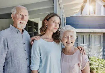 An older woman with her mother and father