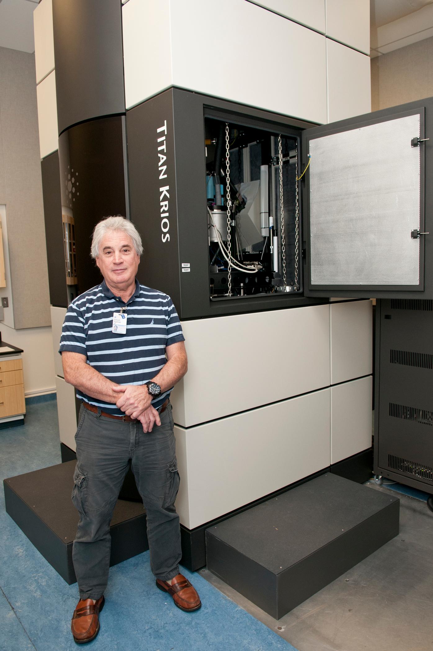 Edward H. Egelman with the massive Titan Krios microscope that’s buried in tons of concrete under Fontaine Research Park.