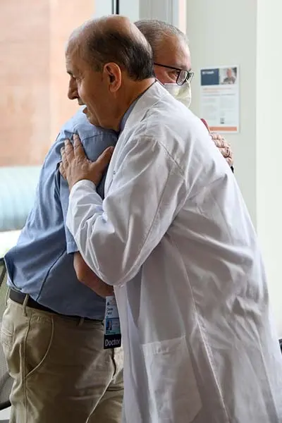 Dr. Fadul and David share a hug as they celebrate his successful treatment