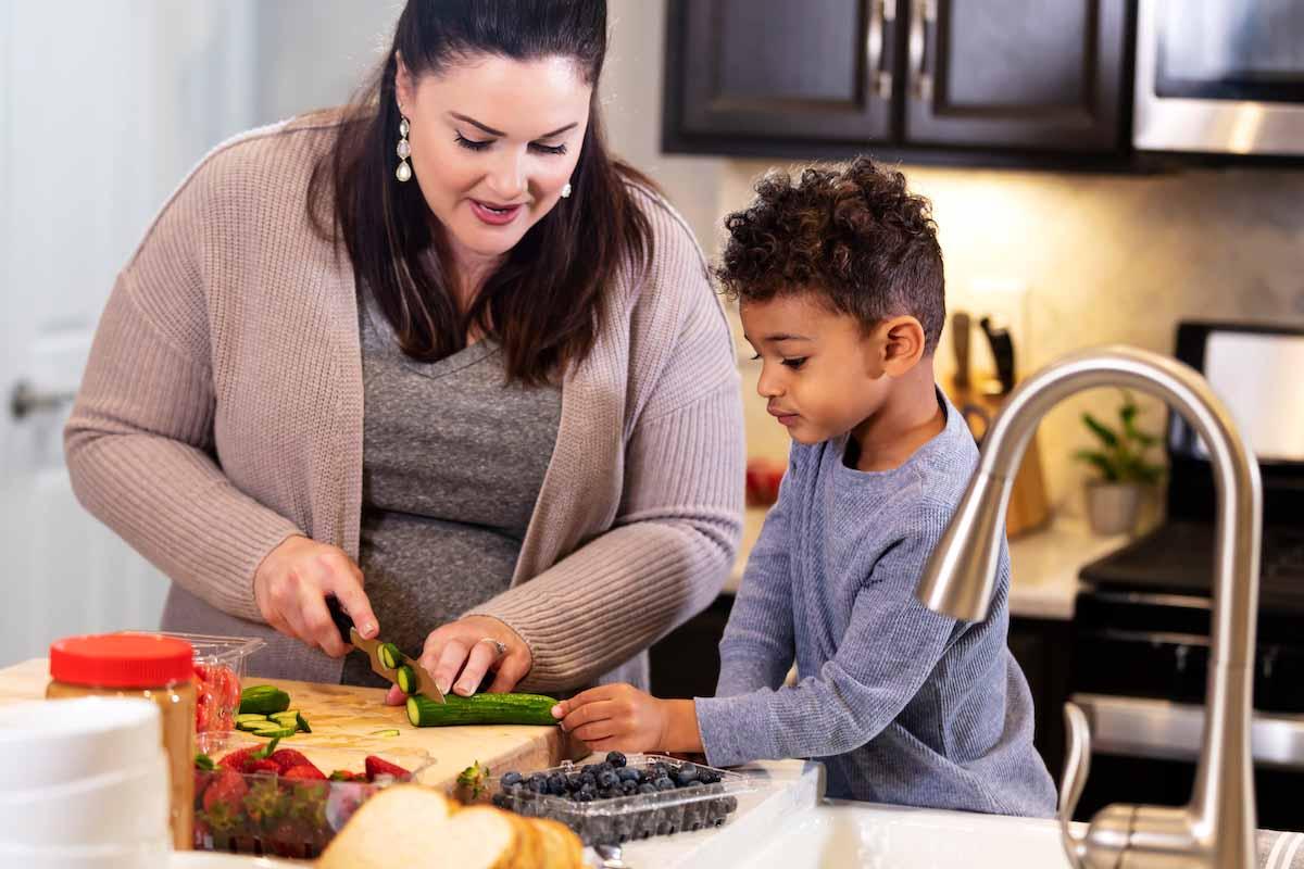 mother and son cutting vegetables