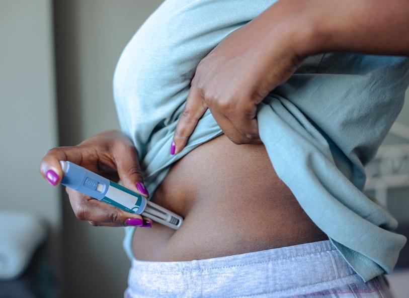 A person injecting themselves with a GLP-1, which may improve obesity-related HFpEF