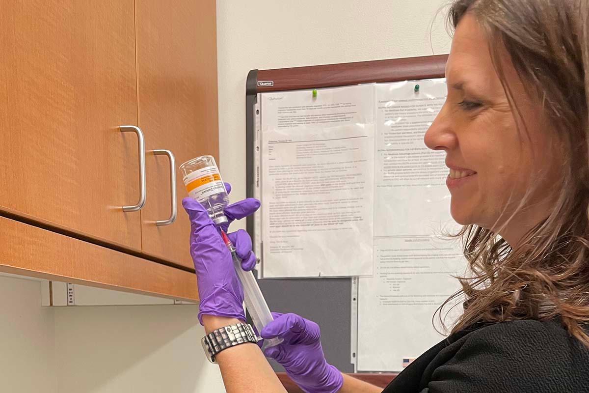 A pharmacist draws up an injection