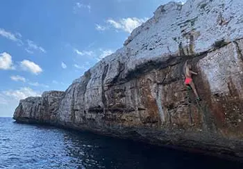 Allie Redshaw doing a deep-water solo climb.