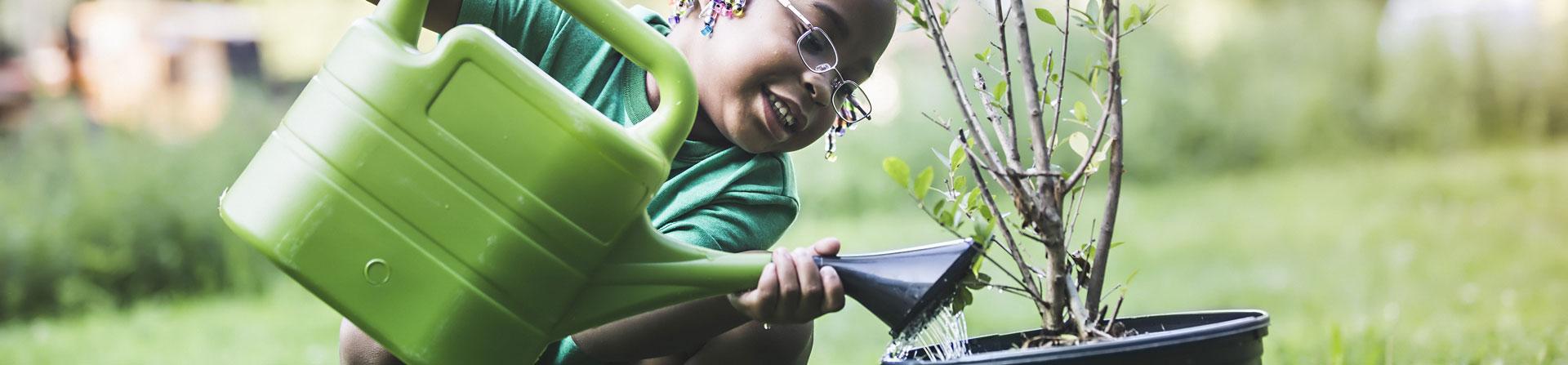 young girl planting a tree