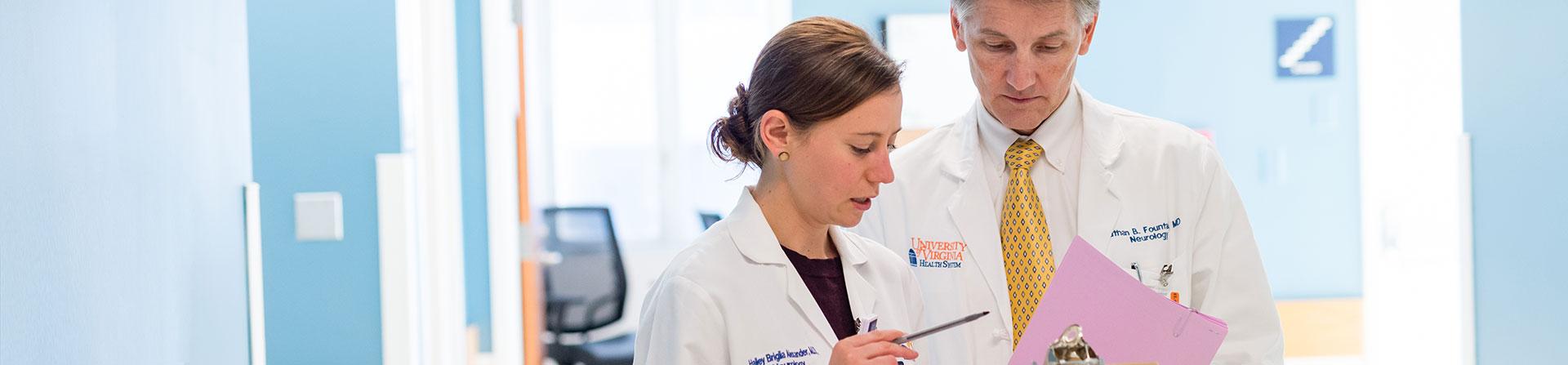 Two neurologists reviewing test results.